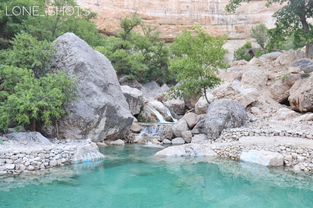 green water and gray rocks