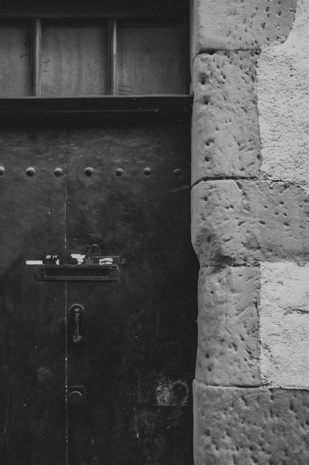 black wooden door with padlock