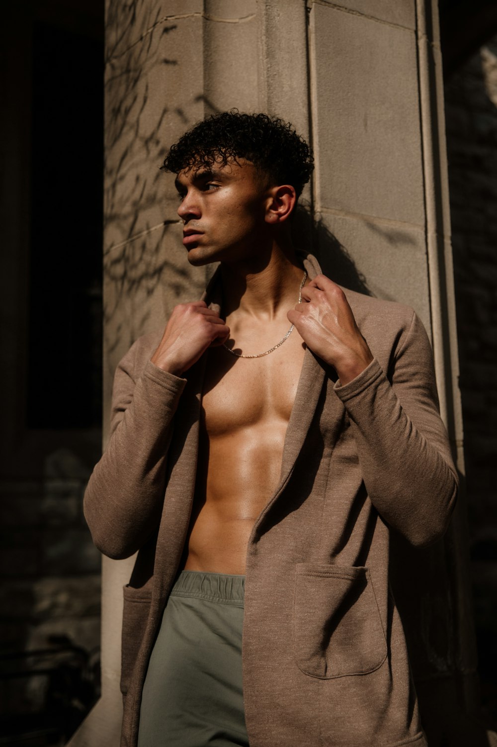 man in gray long sleeve shirt and gray denim jeans