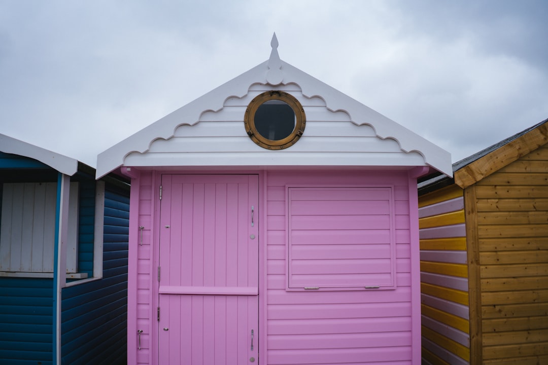 pink wooden door with brass door knob