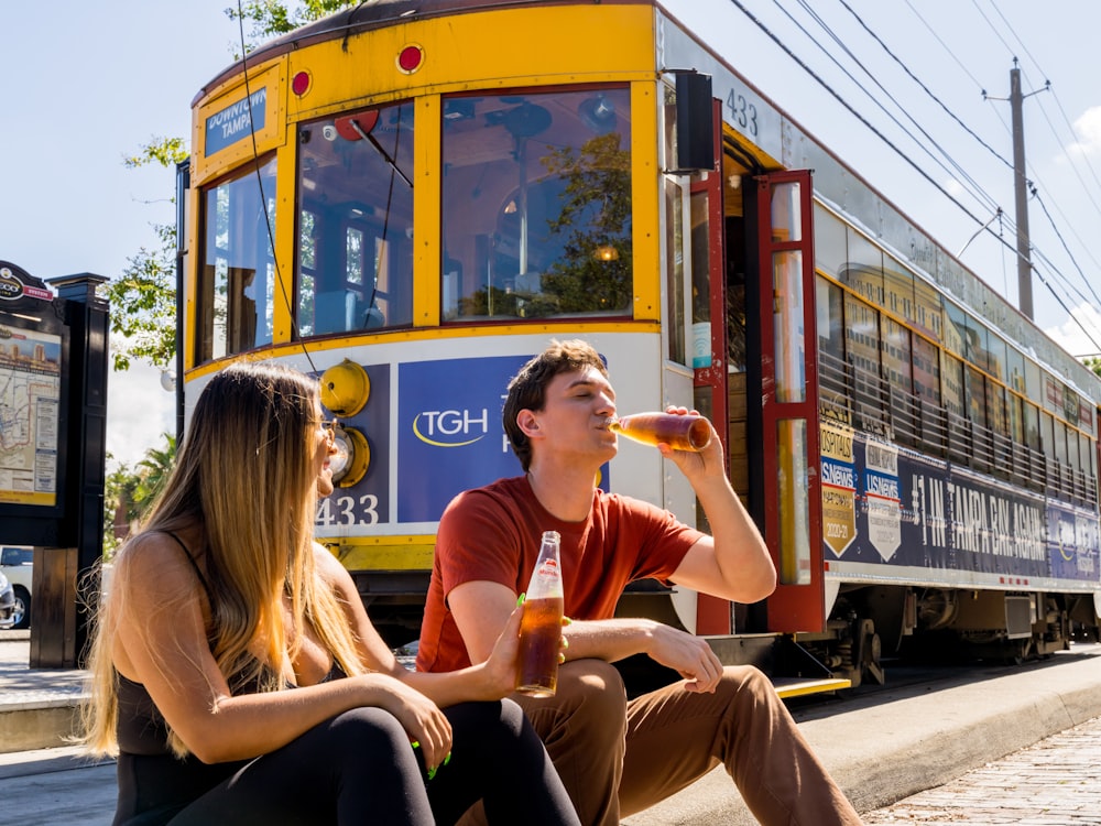 woman in pink t-shirt sitting on yellow and black bus during daytime