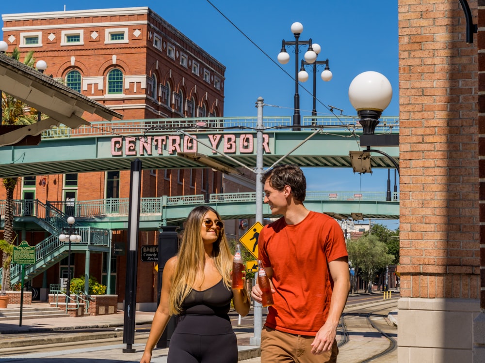 man in red crew neck t-shirt standing beside woman in yellow t-shirt