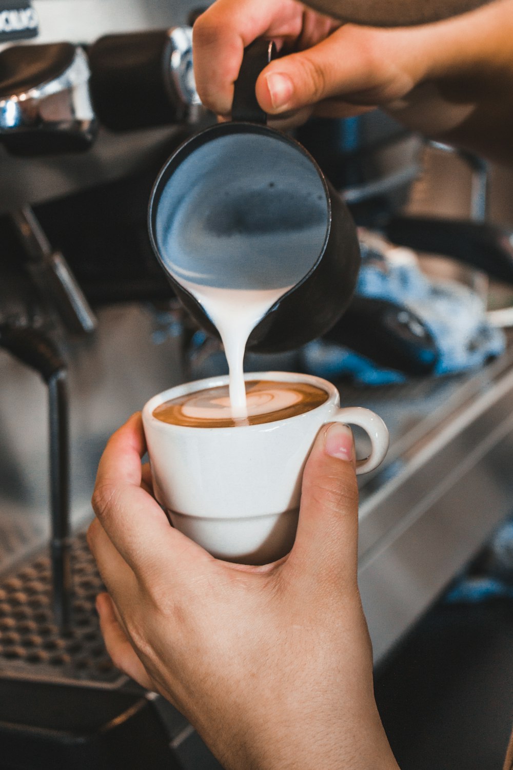 person holding white ceramic mug with coffee