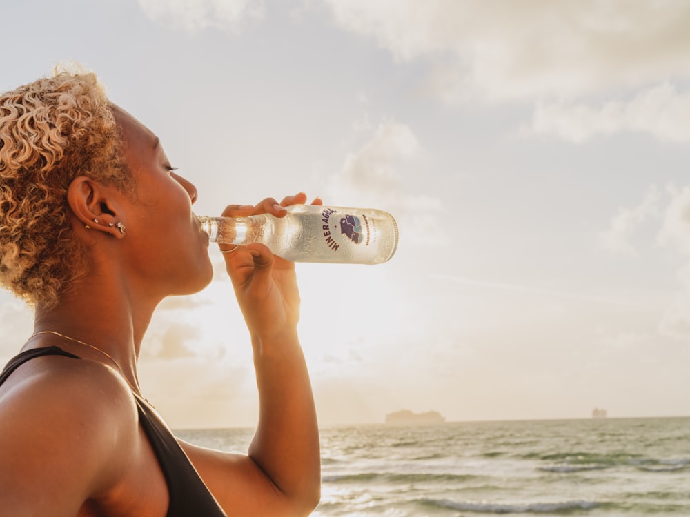 woman drinking from a bottle