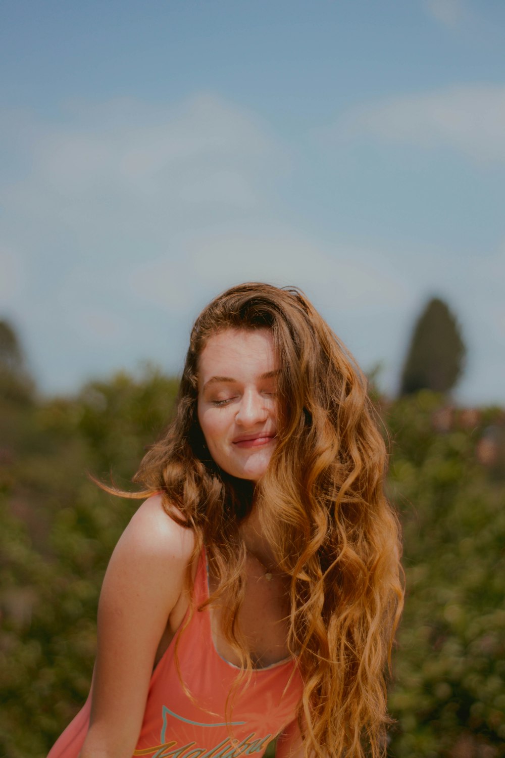 woman in pink tank top smiling