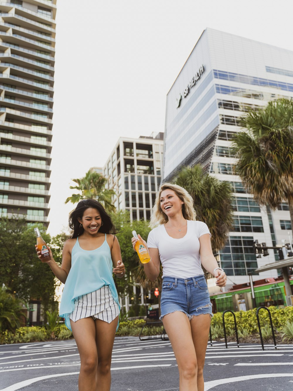 2 women standing on green grass field during daytime