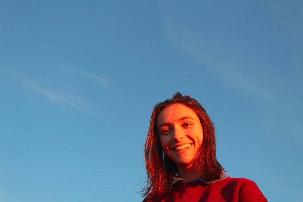 woman in red hoodie smiling