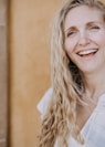 smiling woman in white lace shirt