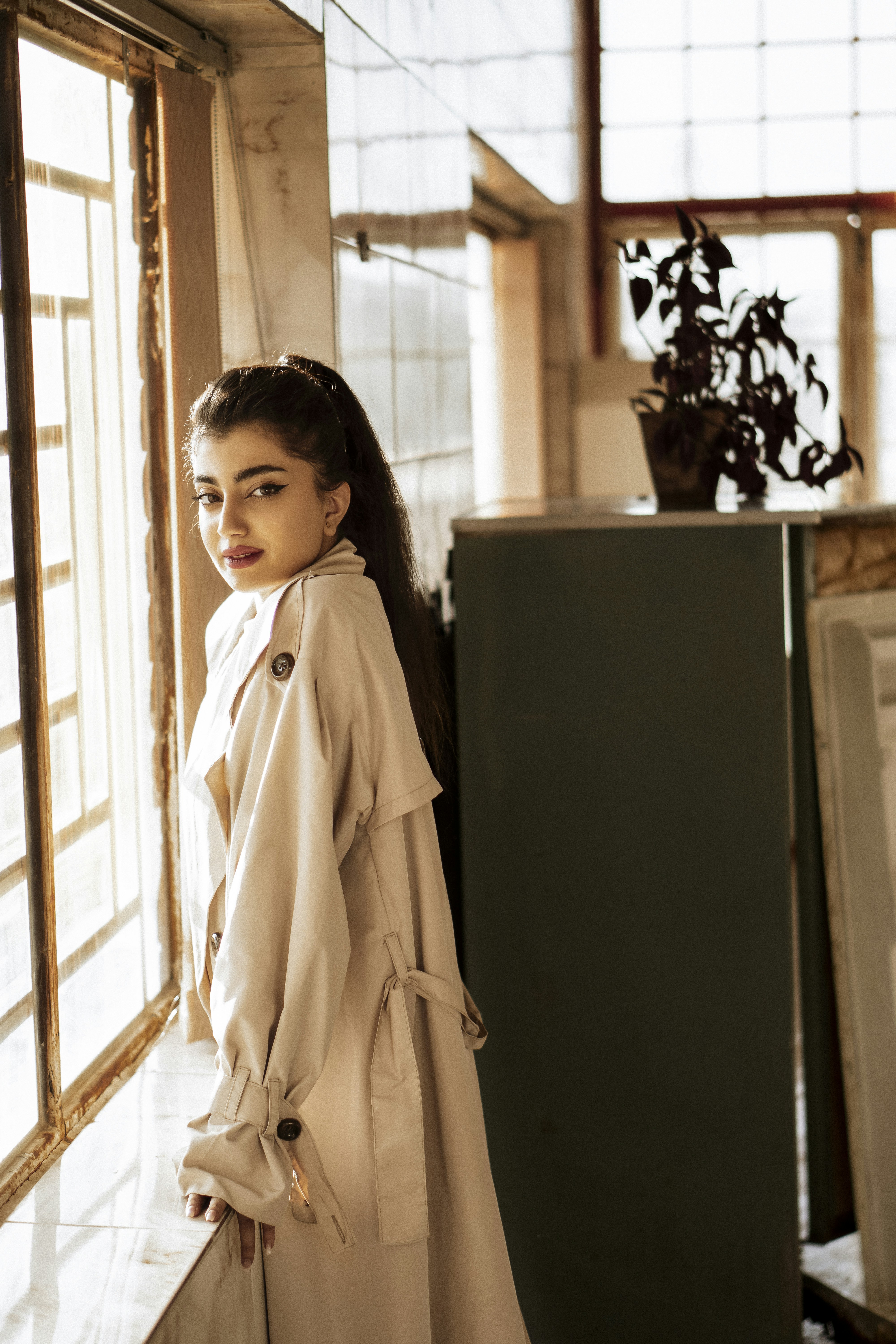 Girl In White Coat Standing Beside Black Refrigerator