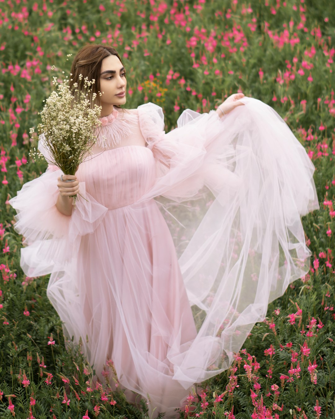 woman in white dress holding bouquet of flowers