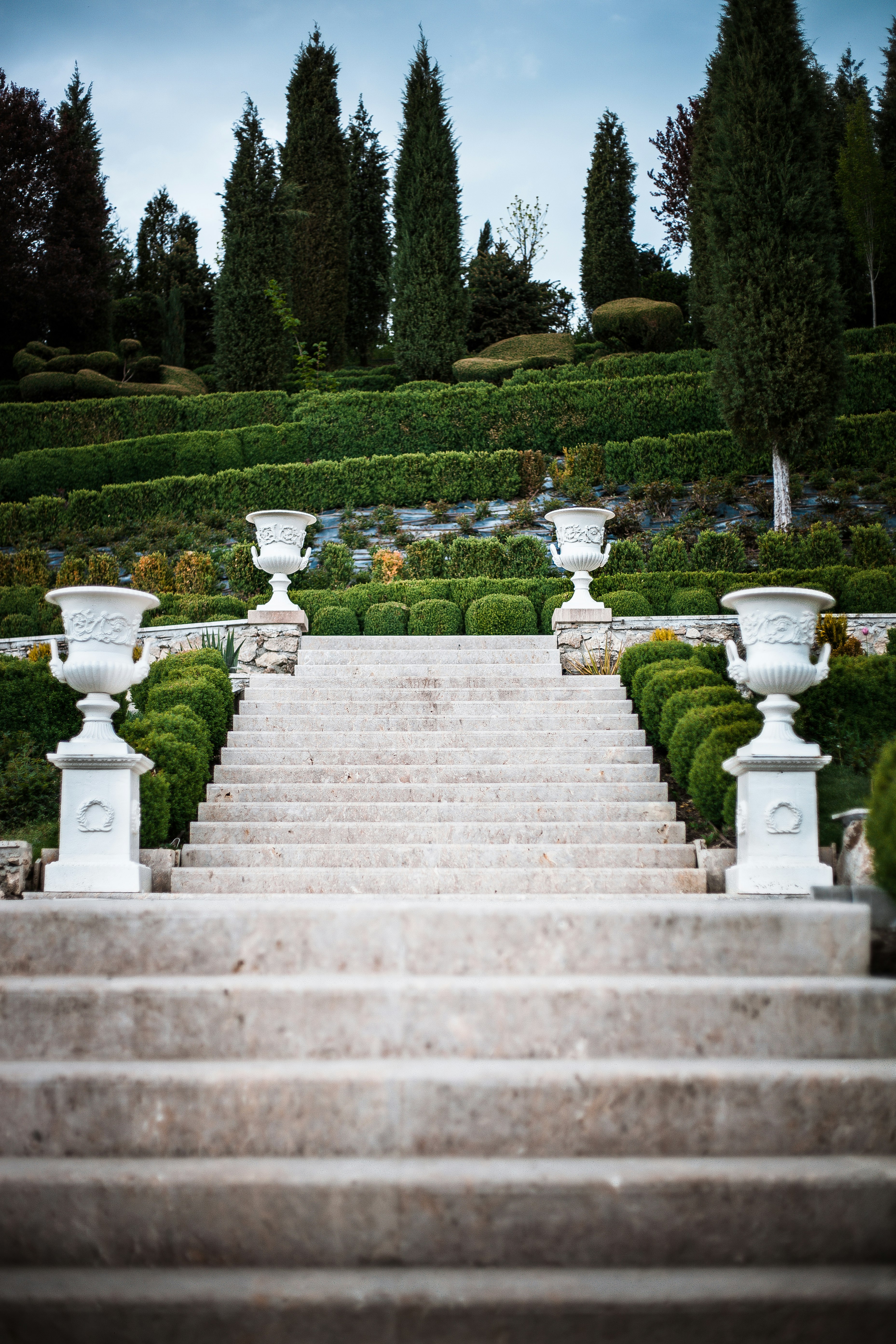 white concrete staircase near green grass field during daytime