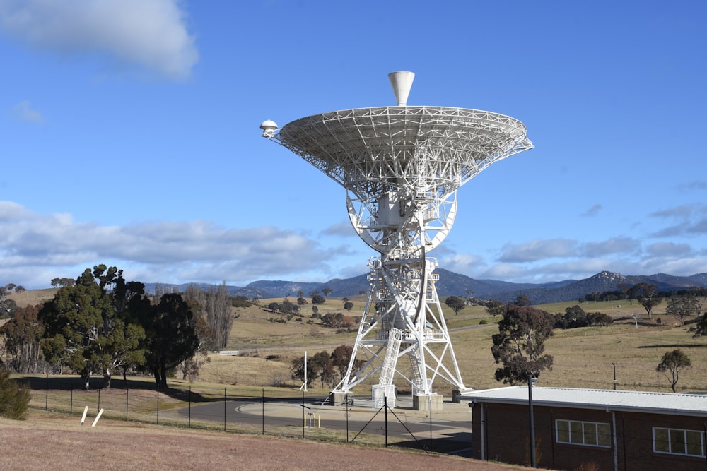 white satellite dish on green grass field during daytime