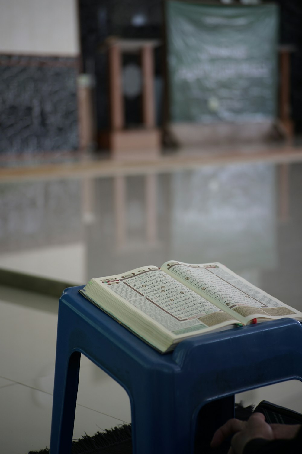 white book on blue plastic container