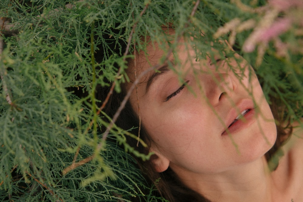 woman lying on green grass