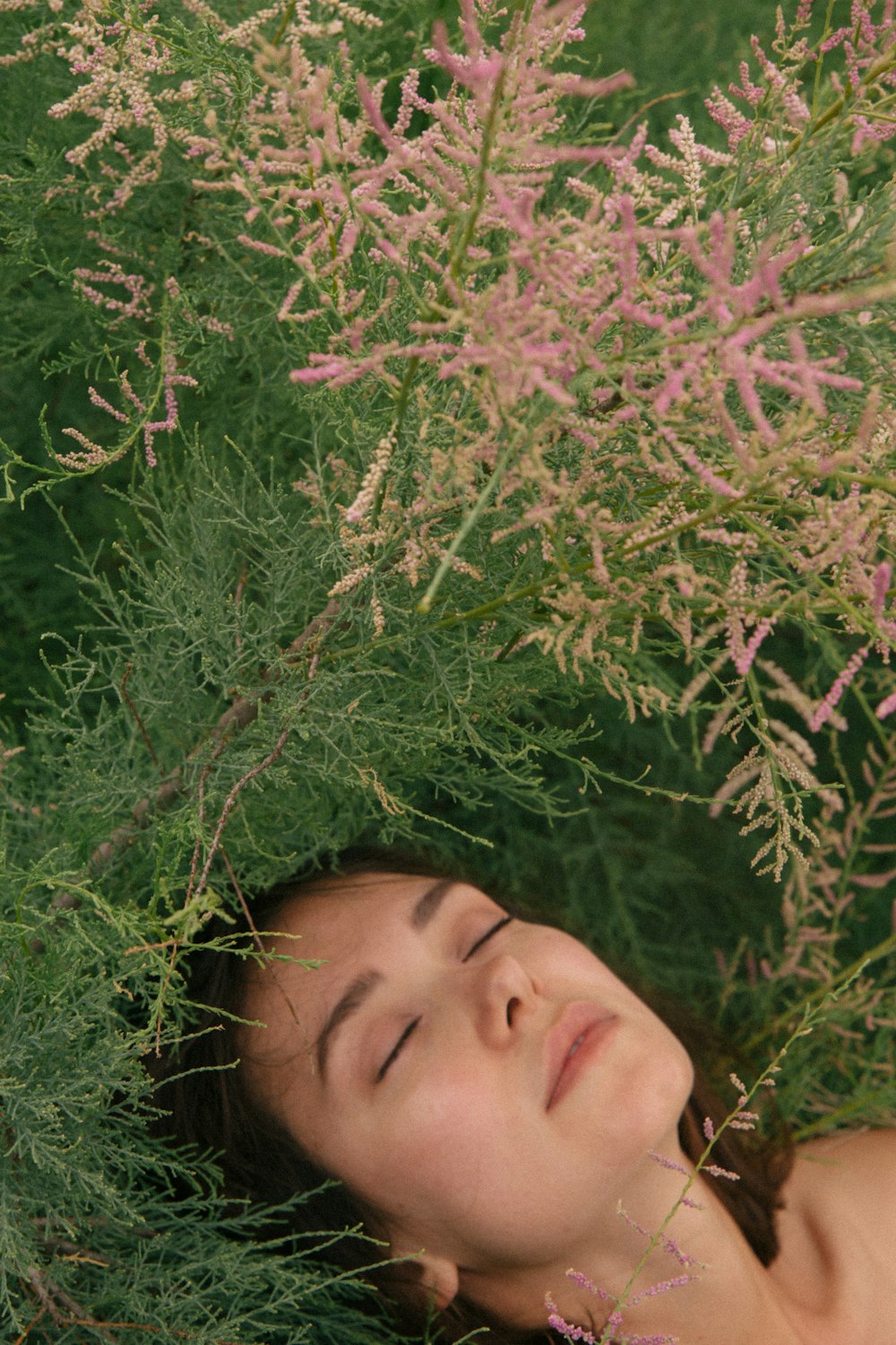 woman lying on green grass