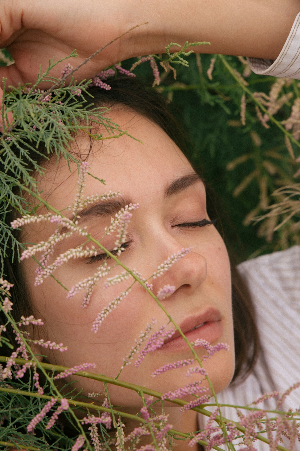 woman with pink flower on her face