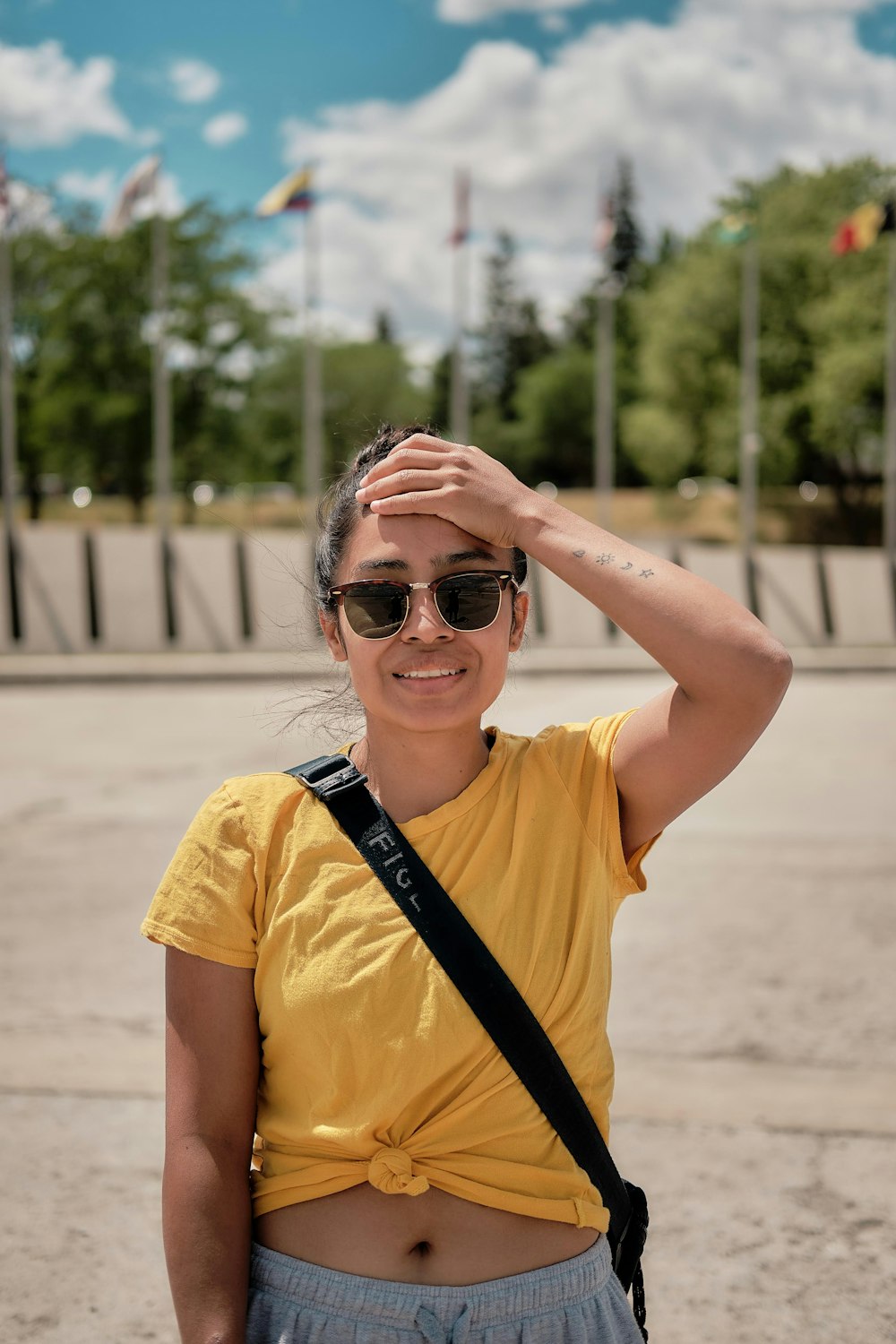 woman in yellow crew neck t-shirt wearing black sunglasses