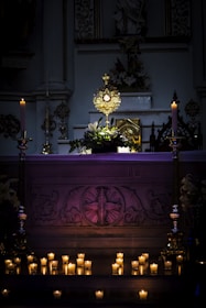 a church altar with lit candles in front of it