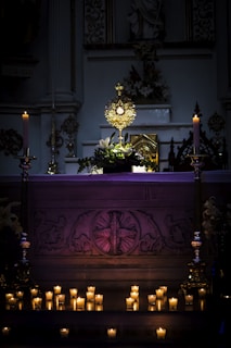 a church altar with lit candles in front of it