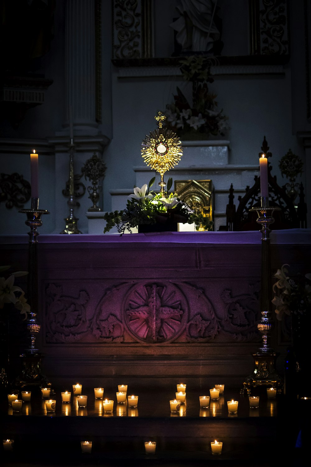 a church altar with lit candles in front of it