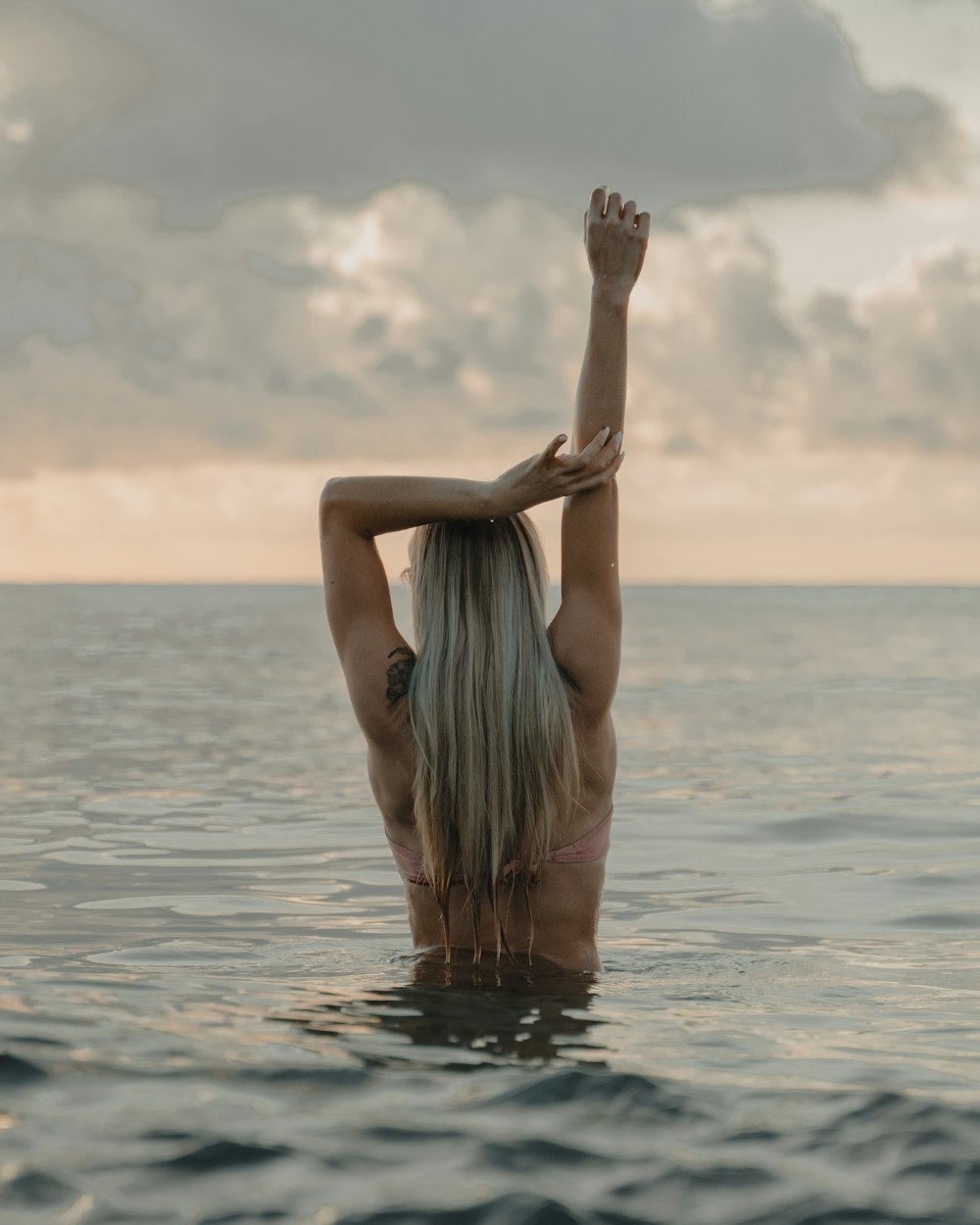 woman in white and black stripe dress on water