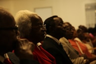 woman in black blazer wearing eyeglasses