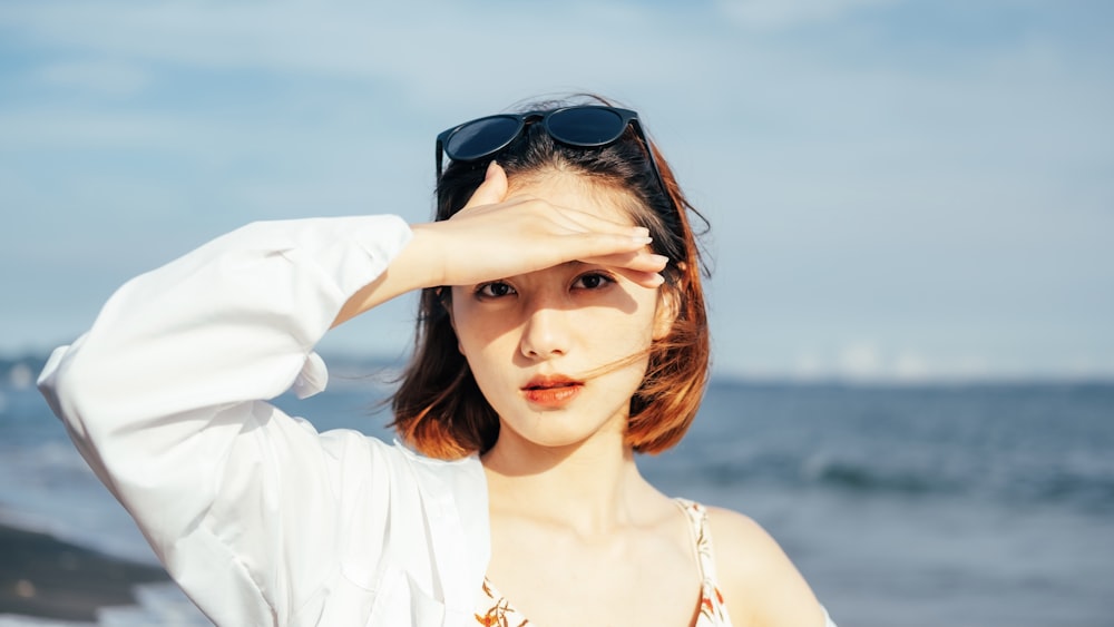 woman in white shirt wearing black sunglasses