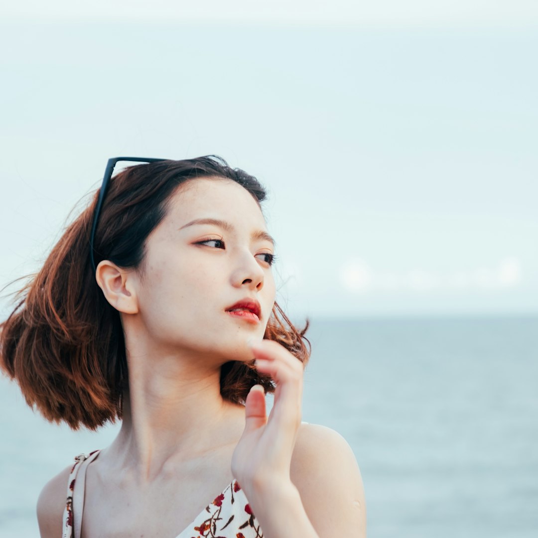 woman in white and red floral tank top