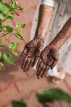 brown and black hand tattoo