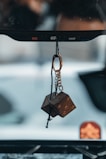 brown wooden pendant with black and brown necklace