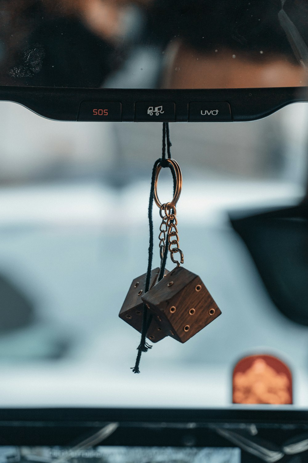 brown wooden pendant with black and brown necklace