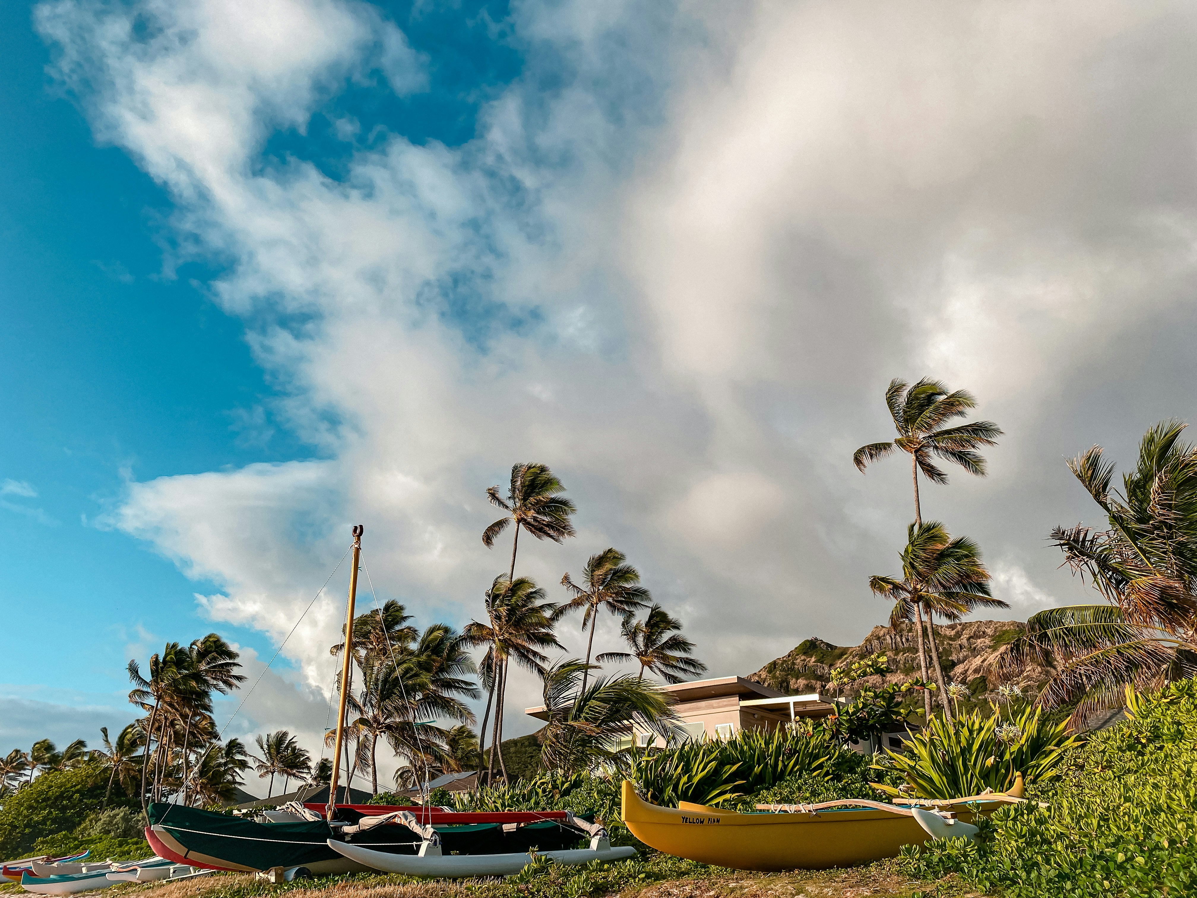 yellow and red boat on body of water under cloudy sky during daytime, Lanikai Shore