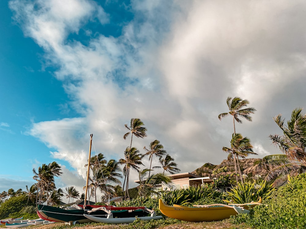 yellow and red boat on body of water under cloudy sky during daytime