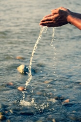 person holding water splash during daytime