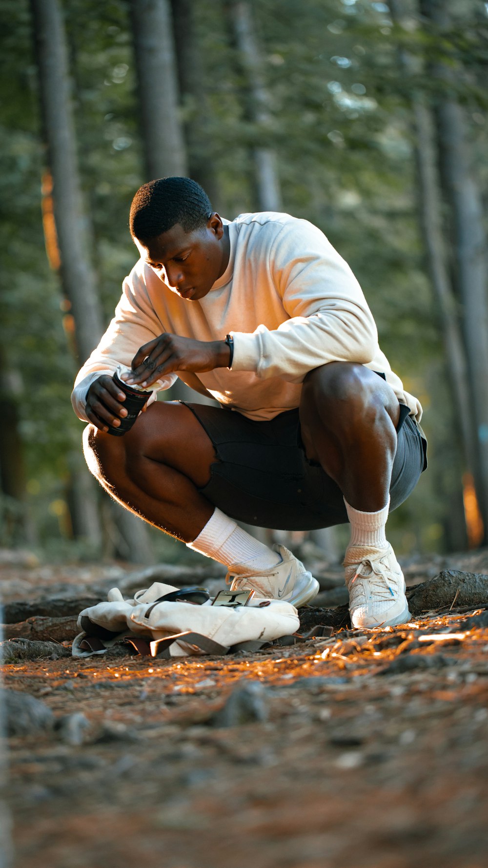 man in white dress shirt and black pants sitting on ground