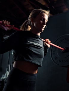 woman in black long sleeve shirt holding red stick
