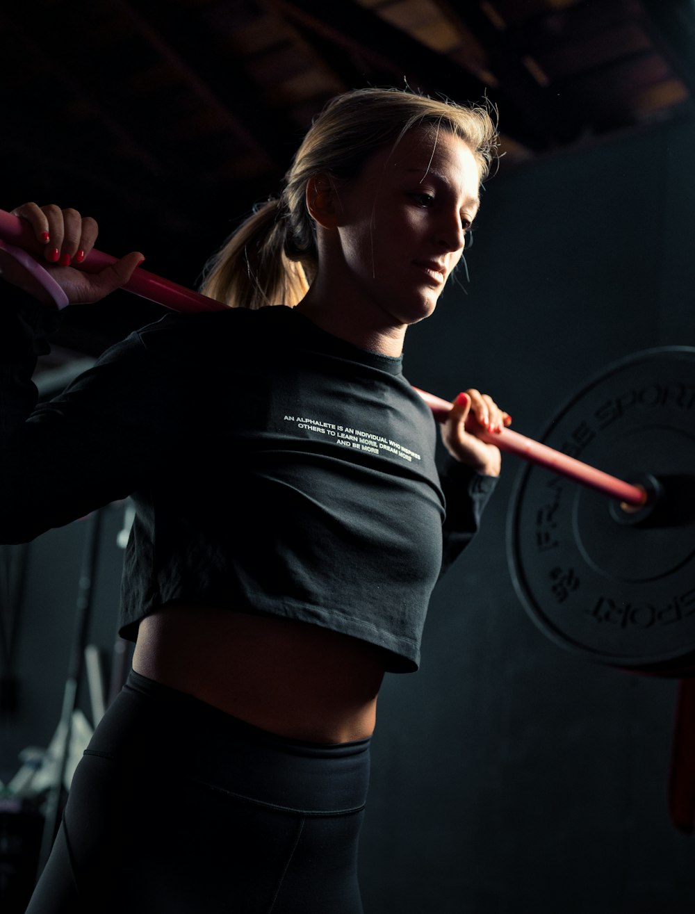 woman in black long sleeve shirt holding red stick