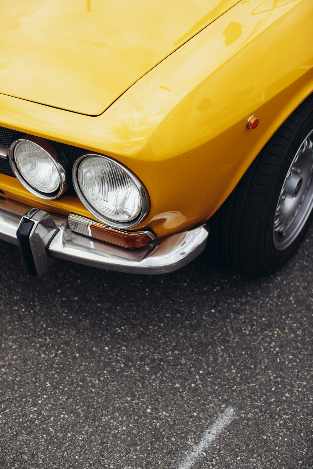 yellow car on black asphalt road