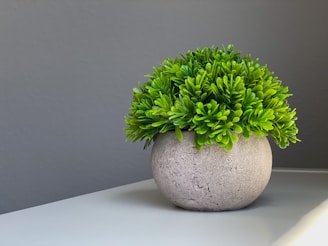 Elegant decorative planters holding lush artificial plants in a well-lit space.