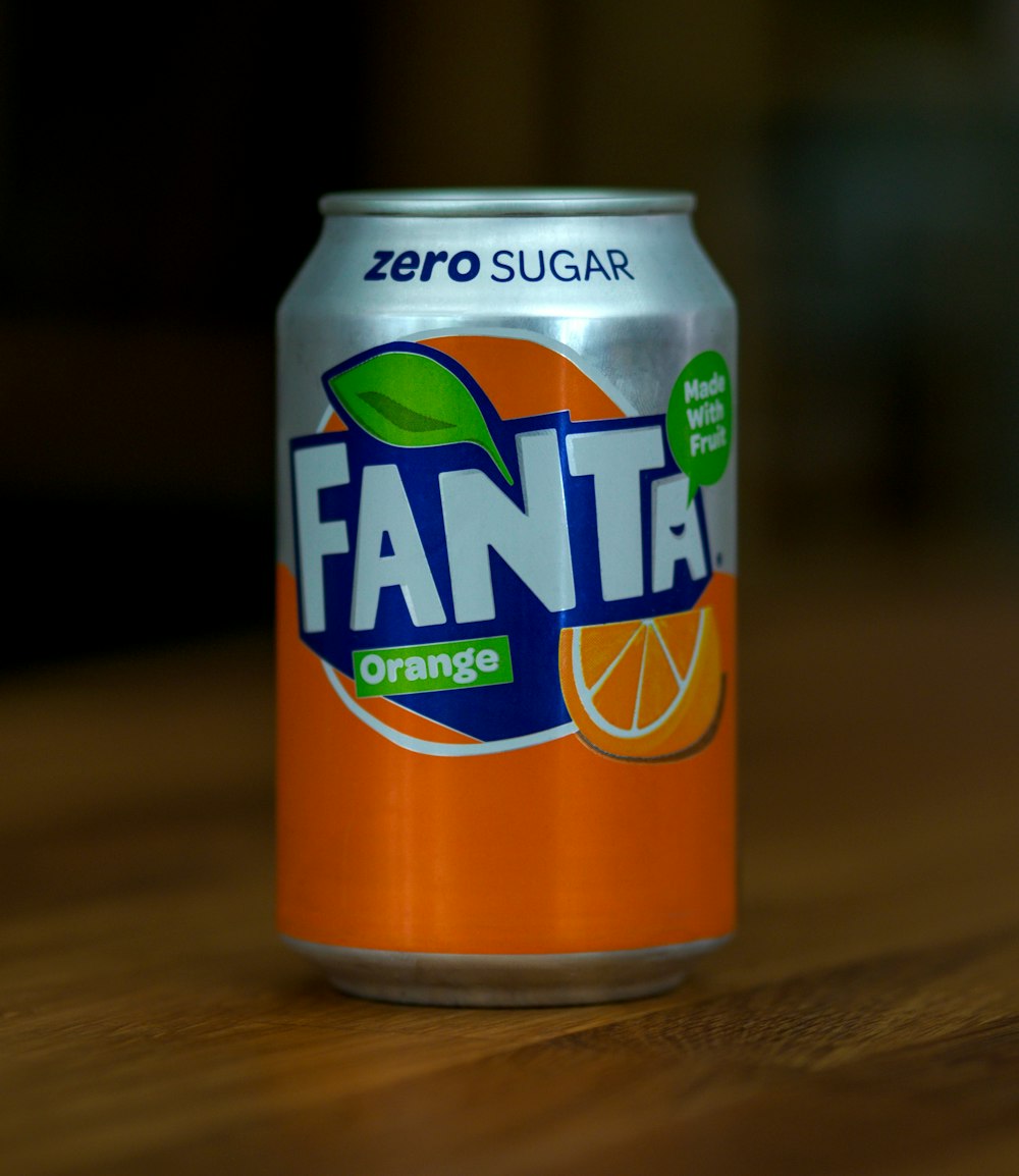 fanta orange can on brown wooden table