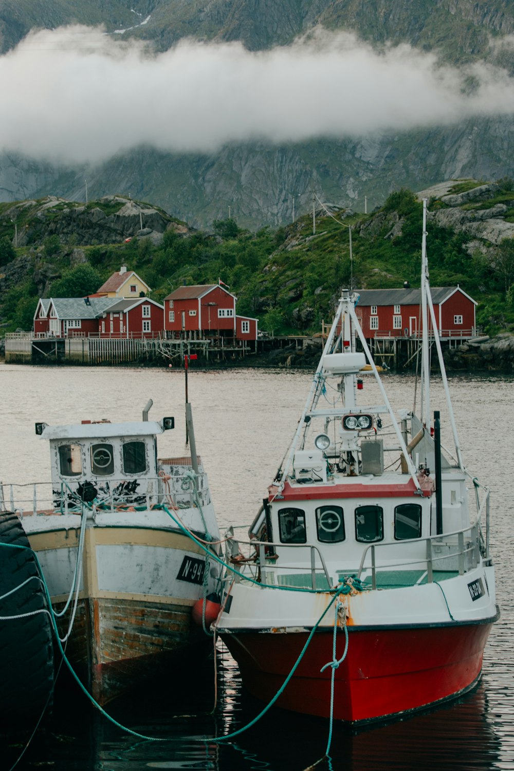 white and green boat on sea during daytime