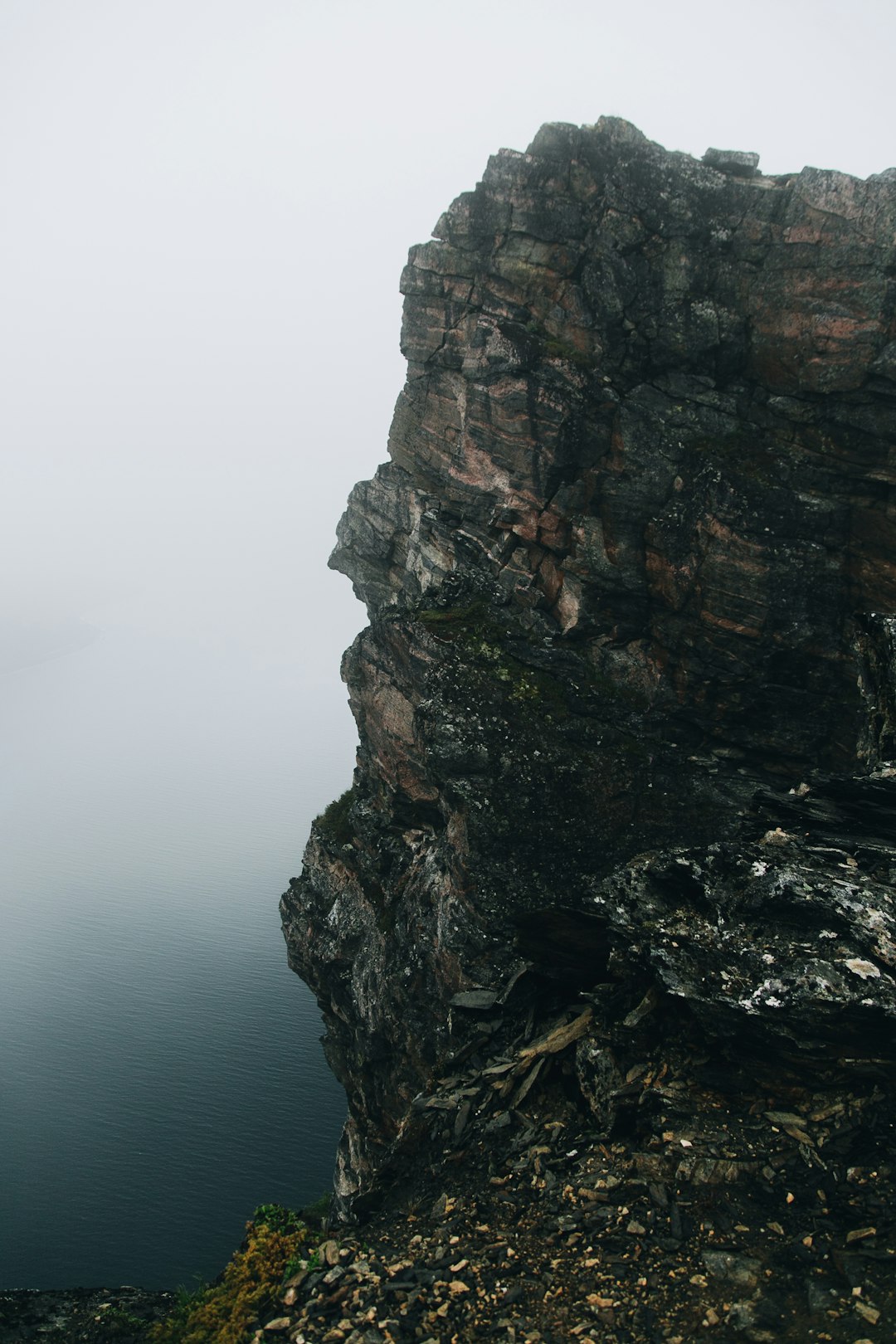 brown rock formation near body of water during daytime