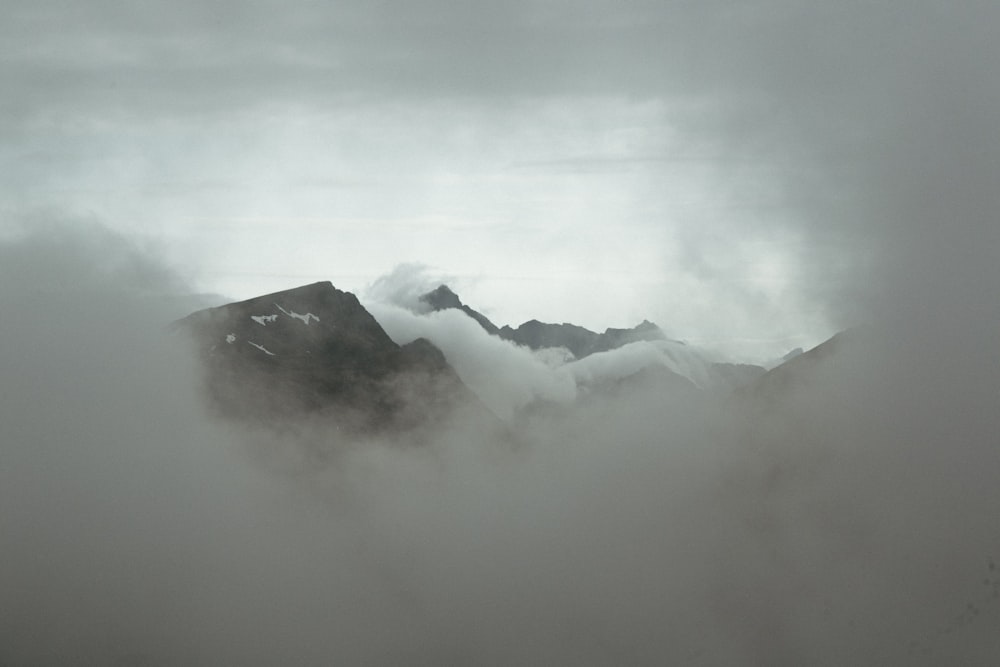 black mountains covered by white clouds