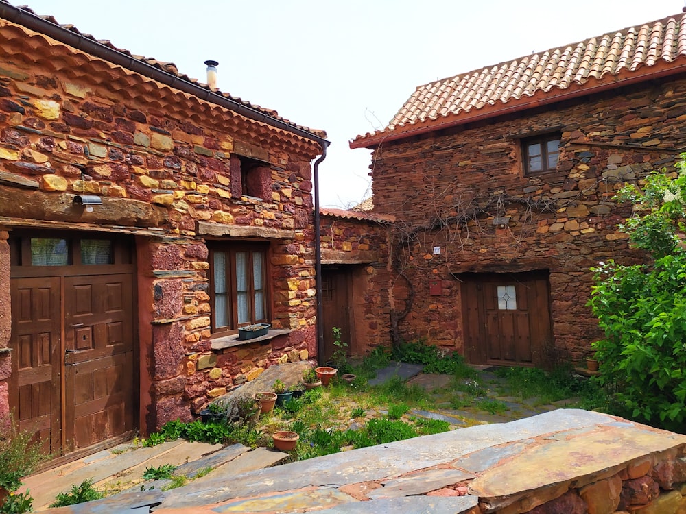 brown brick house with green grass and brown brick walls