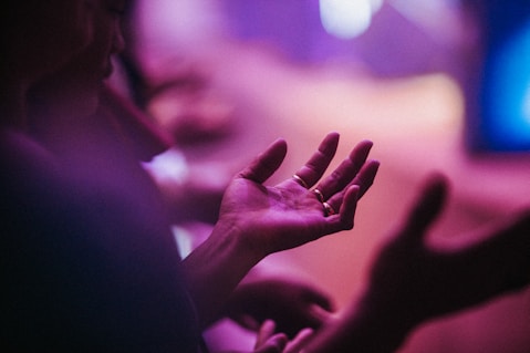 person raising his left hand