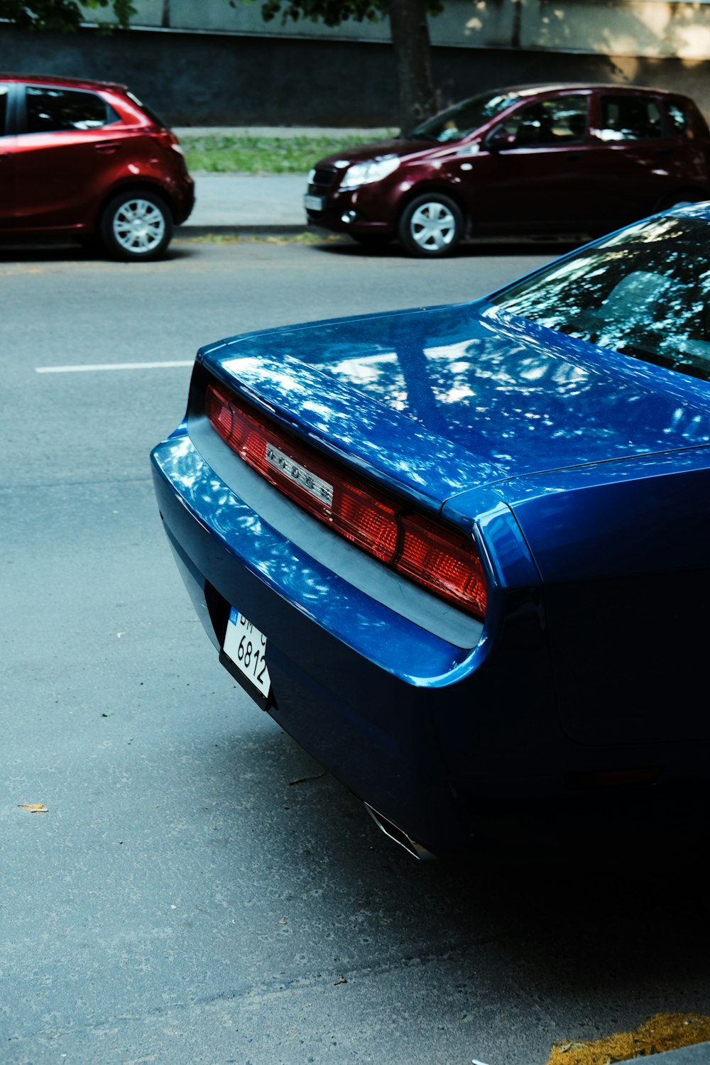 blue car on gray asphalt road during daytime