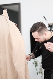 man in brown coat holding black rope