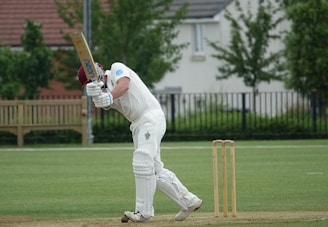 man in white pants playing baseball during daytime