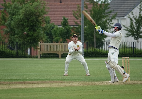 man in white jersey shirt and pants playing baseball during daytime