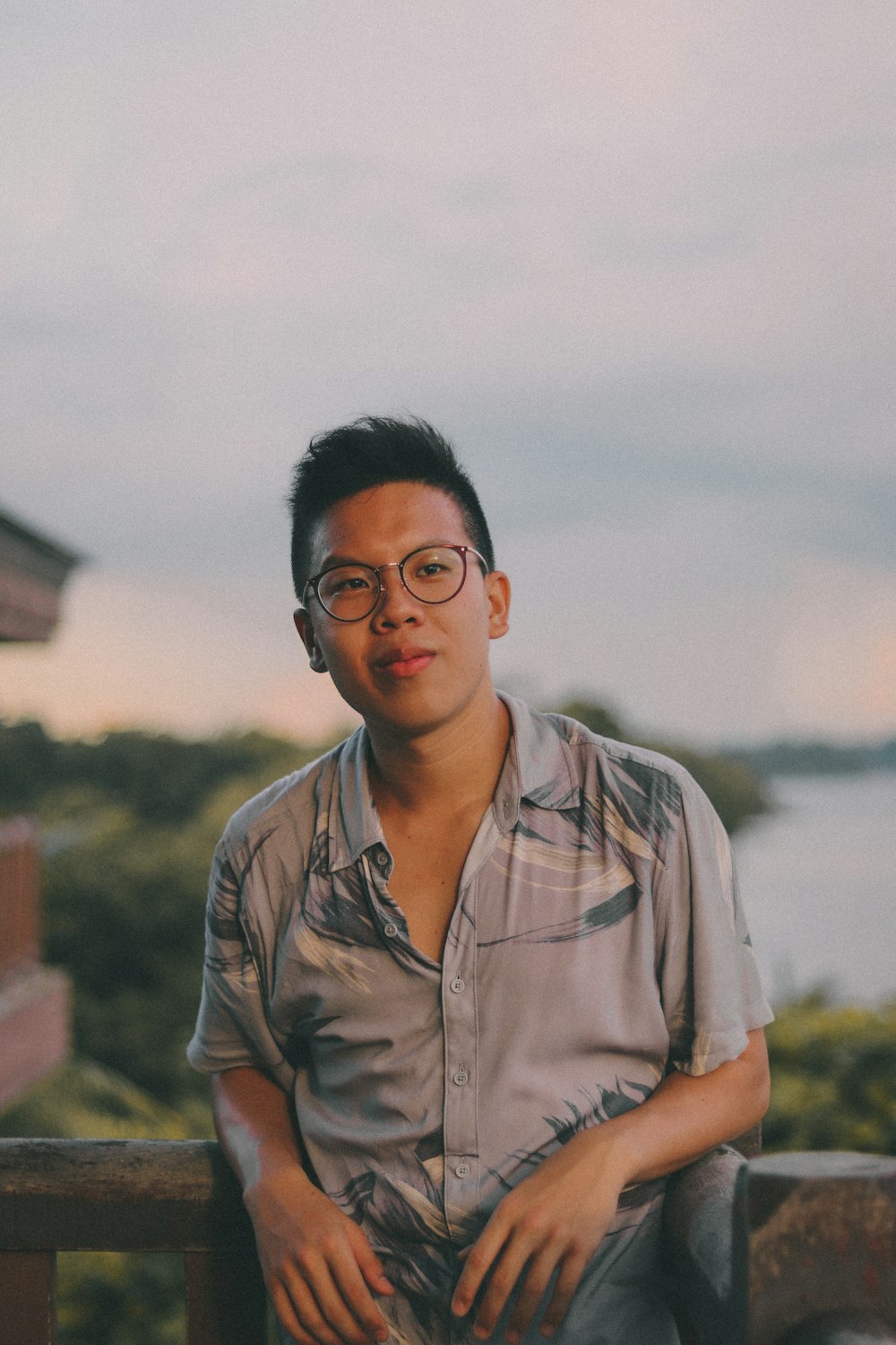 man in brown button up shirt standing near body of water during daytime